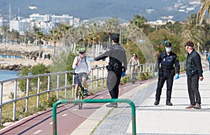 Spanish police wearing protective mask patrol to stop and warn the citizens to get back to their houses as a quarantine is set