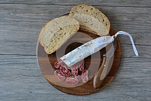 Spanish pork sausage, dark bread and rustic knife