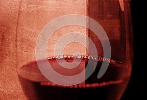 Spanish red wine Glass with bubbles and bottle on grunge arty background photo