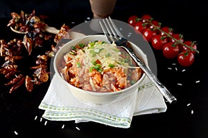 Spanish rice with grated cheddar cheese and spring onions