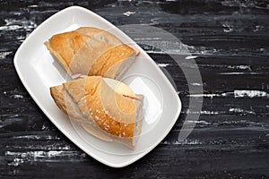 a spanish rosca de jamon serrano, ham sandwich, on a white plate