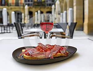 Spanish rose wine and Jamon Iberico ham sandwich at a restaurant, Pamplona Spain