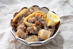 Spanish sea food, cripsy deep fried baby octopus, fish, calamari rings served with lemon