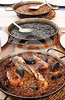 Spanish seafood paella, black paella and fideua photo