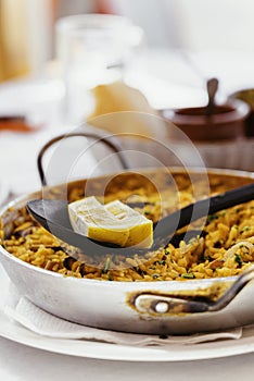 Spanish Seafood Paella with mussels, shrimps and a piece of lemon. in a steel paella pan. Canary islands cousine in a