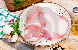 Spanish Secreto de cerdo - raw pork cinch with parsley and peppers in plate