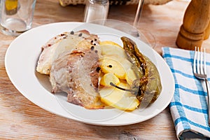 Spanish Secreto de cerdo - roasted pork served with potatoes, stewed pepper photo