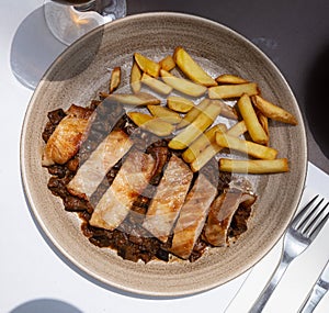 Spanish secreto iberico - iberian pork in sweet wine with stewed vegetables photo