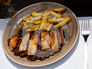 Spanish secreto iberico - iberian pork in sweet wine with stewed vegetables photo