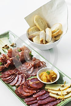 Spanish serrano ham chorizo sausage and cheese tapas platter