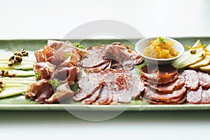 Spanish serrano ham chorizo sausage and cheese tapas platter