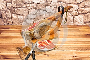 Spanish serrano ham on the leg with wood holder photo