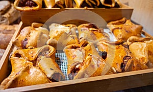 Spanish snacks and street food, baked pie empanadilla with different filling on market in San-Sebastian, Spain