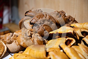 Spanish snacks and street food, baked pie empanadilla with different filling on market in San-Sebastian, Spain