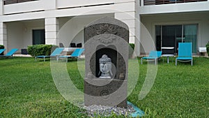 A Spanish Statue sitting in a Grassy Area