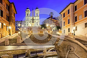 Spanish Steps, Piazza di Spagna, Fountain della Barcaccia and Trinita dei Monti church during morning sunrise in Rome, Italy