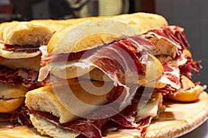 Spanish street food bocadillo fresh bread with jamon iberico ready to eat photo