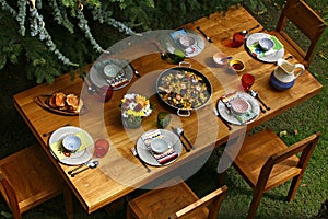 Spanish style dining table with paella, overview photo