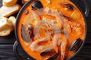 Spanish Suquet de Peix soup with seafood, potatoes, herbs and fi
