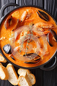 Spanish Suquet de Peix soup with seafood, potatoes, herbs and fi