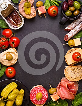 Spanish tapas on a black stone background