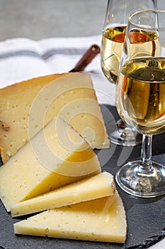 Spanish tapas, manchego cheese made, green olives served with glasses of dry fino sherry wine