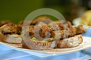 Spanish tapas. Pinchos morunos on bread. Montaditos photo