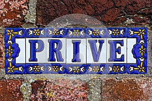 Spanish tile sign with the Dutch word Prive which means: Private