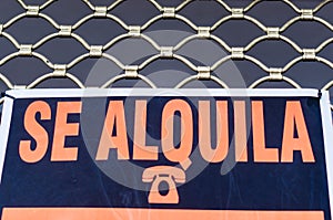 Spanish Ã¢â¬ÅTo rentÃ¢â¬Â signboard on the facade of a house photo