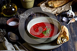 Spanish tomato soup gazpacho on a wooden background. Dark food photography