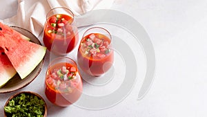 Spanish tomato and watermelon gazpacho cold soup styled and decorated in glasses