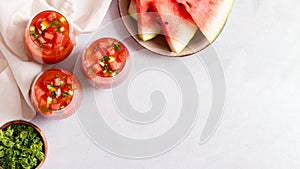 Spanish tomato and watermelon gazpacho cold soup styled and decorated in glasses