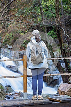 Spanish tourist woman looking a small river in the Spanish mountain Montseny