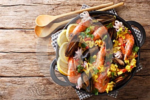 Spanish traditional cuisine: hot paella with seafood shrimps, mu