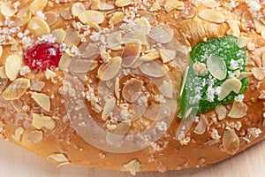 Spanish typical Epiphany cake Roscon de Reyes on a wooden background