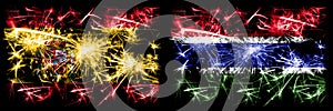 Spanish vs Gambia, Gambian New Year celebration sparkling fireworks flags concept background. Combination of two abstract states