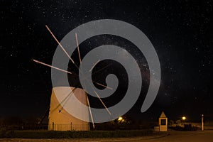 A Spanish windmill at night with the Milky Way galaxy in the sky.