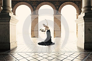 Spanish woman dancing flamenco dance in a beautiful monumental place