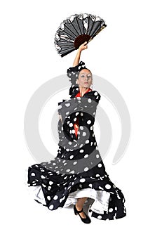 Spanish woman dancing Sevillanas wearing fan and typical folk black with white dots dress photo