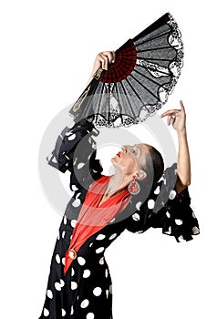 Spanish woman dancing Sevillanas wearing fan and typical folk black with white dots dress photo