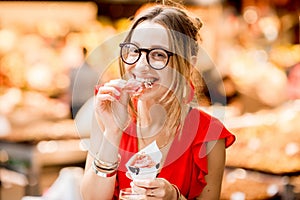 Spanish woman eating jamon at the market