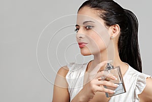 Spanish woman spraying perfume