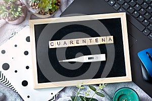 Spanish word cuarentena made of wooden blocks, concept of self quarantine at home as preventative measure against virus outbreak.