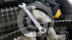 Spanner and timing belt on car engine