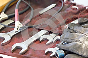 Spanners, Gloves And Tools On Machanic Table.