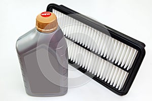 Spare part for car engine air filter for cleaning dust and dirt with bottle on a white isolated background. Maintenance and oil