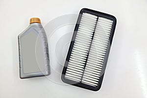 Spare part for car engine air filter for cleaning dust and dirt with bottle on a white isolated background. Maintenance and oil