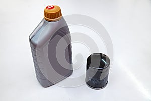 Spare part for car engine  filter for cleaning dust and dirt with one liter bottle or can of lubricant on a white isolated