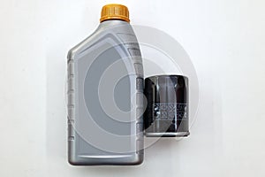 Spare part for car engine  filter for cleaning dust and dirt with one liter bottle or can of lubricant on a white isolated