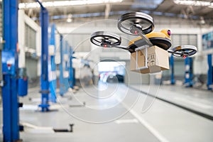 Spare part delivery drone at garage storage in leading automotive car service center for delivering mechanical shipping component